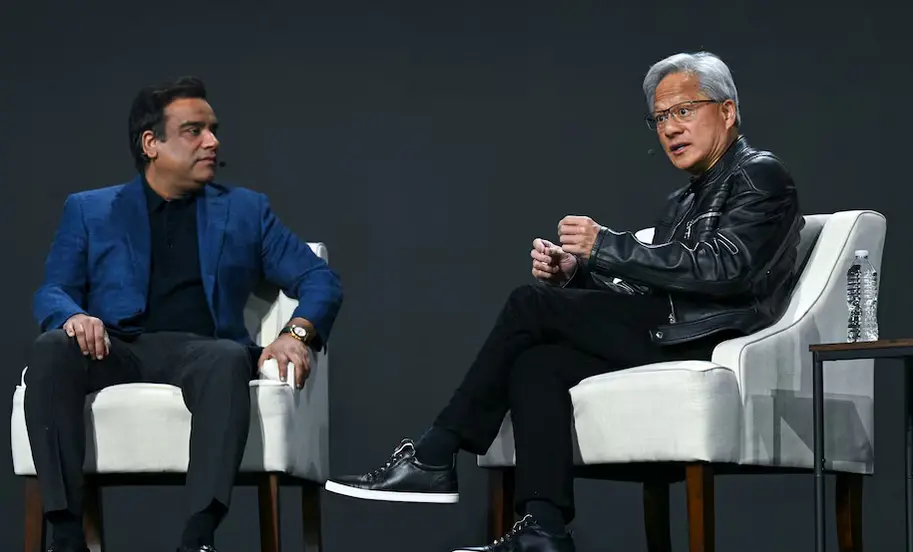 Anirudh Devgan watches as Jensen Huang speaks at CadenceLIVE in Santa Clara, highlighting collaboration between Cadence and Nvidia.